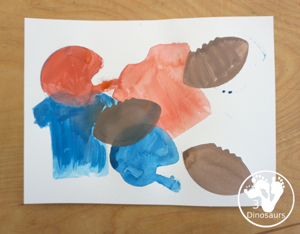 Football Cookie Cutter Watercolor Painting - a fun painting that kids can do with a football theme. A great way to do a fun watercolor painting is by different football team colors. - 3Dinosaurs.com