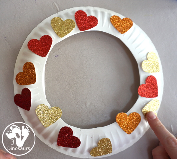 Rainbow Heart Wreath - made with glitter hearts and a paper plate that is super simple to put together for  heart theme of Valentines - 3Dinosaurs.com