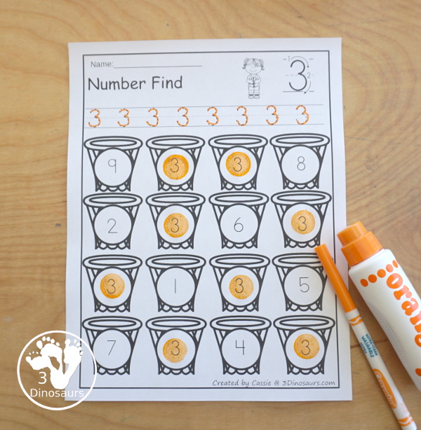 Basketball Number Find Printable with numbers 0 to 20. It has numerical numbers and number words. You have handwriting for numbers and the search and find the numbers on the hoops - 3Dinosaurs.com