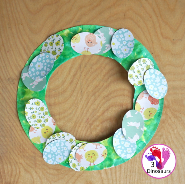  Easter Wreath Craft for Kids a simple easter wreath you can make with scrapbook paper and paper plate. A perfect craft for kids to make. - 3Dinosaurs.com