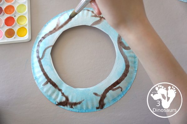 Cherry Blossom Wreath is a great spring wreath that kids can make with a paper plate for the base and watercolor and cherry blossom punches for the flowers. The Cherry Blossom Wreath is perfect for spring. - 3Dinosaurs.com