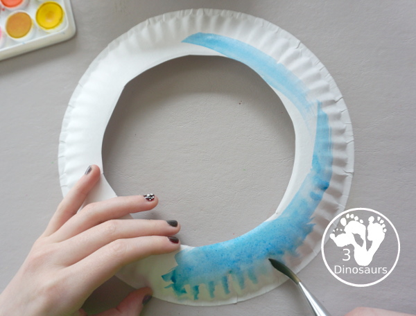 Spring Tree Wreath Craft For Kids is a paper plate wreath that you can make with kids for spring. It is super fun and easy to make. - 3Dinosaurs.com