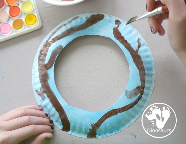 Spring Tree Wreath Craft For Kids is a paper plate wreath that you can make with kids for spring. It is super fun and easy to make. - 3Dinosaurs.com