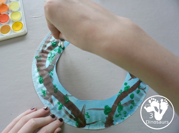 Spring Tree Wreath Craft For Kids is a paper plate wreath that you can make with kids for spring. It is super fun and easy to make. - 3Dinosaurs.com