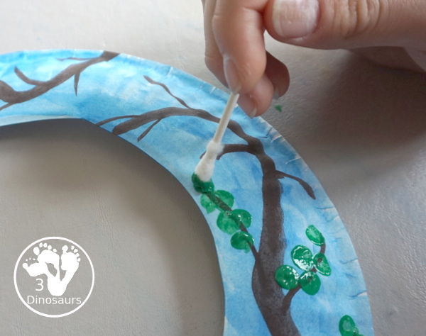 Spring Tree Wreath Craft For Kids is a paper plate wreath that you can make with kids for spring. It is super fun and easy to make. - 3Dinosaurs.com