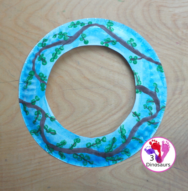 Spring Tree Wreath Craft For Kids is a paper plate wreath that you can make with kids for spring. It is super fun and easy to make. - 3Dinosaurs.com