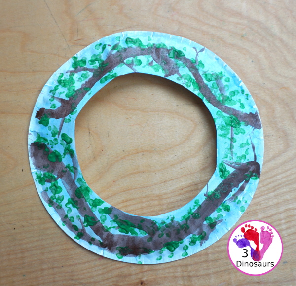 Spring Tree Wreath Craft For Kids is a paper plate wreath that you can make with kids for spring. It is super fun and easy to make. - 3Dinosaurs.com