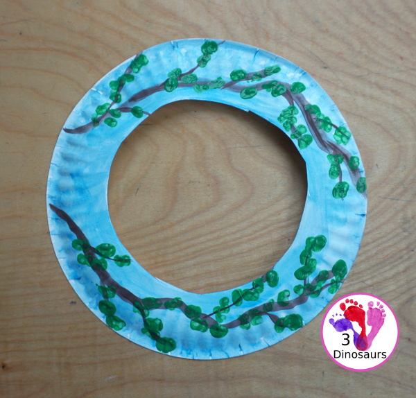 Spring Tree Wreath Craft For Kids is a paper plate wreath that you can make with kids for spring. It is super fun and easy to make. - 3Dinosaurs.com