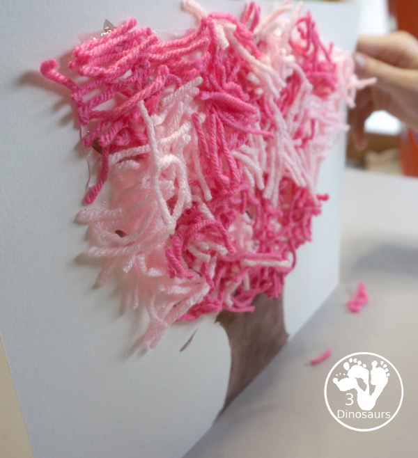 Spring Yarn Tree Craft For Kids - a fun craft made with watercolor for the tree trunk and yarn for the spring blossoms. Super easy to make and great for different ages. - 3Dinosaurs.com