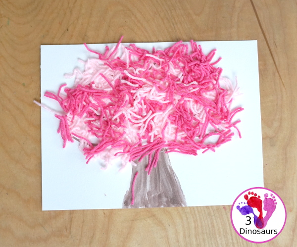 Spring Yarn Tree Craft For Kids - a fun craft made with watercolor for the tree trunk and yarn for the spring blossoms. Super easy to make and great for different ages. - 3Dinosaurs.com