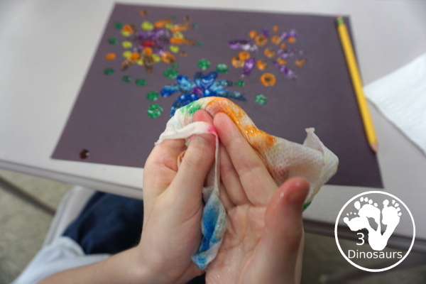 Finger Painting Fireworks with Glitter Paint for kids - easy and fun sensory painting activity that is a great way to make fireworks. - 3Dinosaurs.com