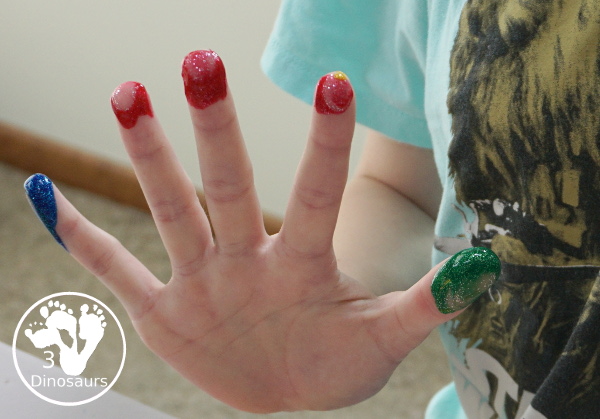 Finger Painting Fireworks with Glitter Paint for kids - easy and fun sensory painting activity that is a great way to make fireworks. - 3Dinosaurs.com