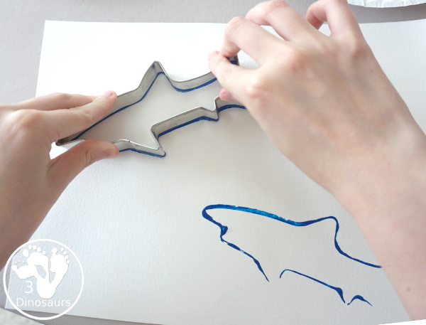 Shark Cookie Cutter Painting - a great painting activity for kids of all ages and works great with tot and preschool age kids for a shark paint activity - 3Dinosaurs.com