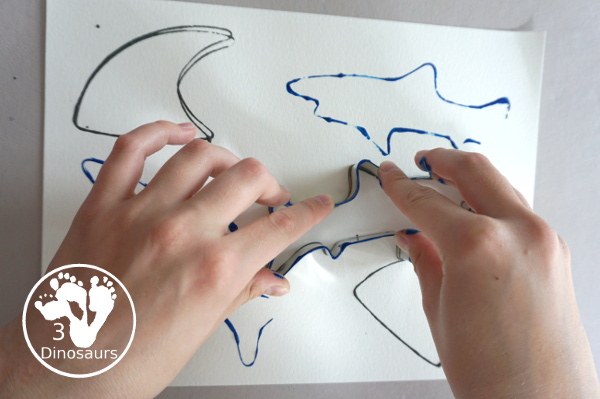 Shark Cookie Cutter Painting - a great painting activity for kids of all ages and works great with tot and preschool age kids for a shark paint activity - 3Dinosaurs.com