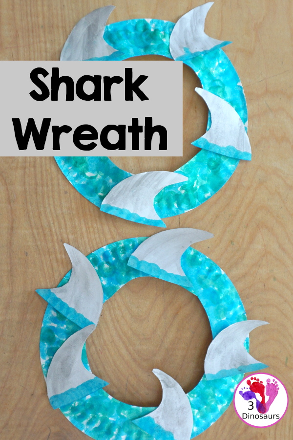 Shark Fin Wreath Craft for Shark Week - that kids can make with a shark cookie cutter and a paper plate. A super easy wreath for all ages.-  3Dinosaurs.com