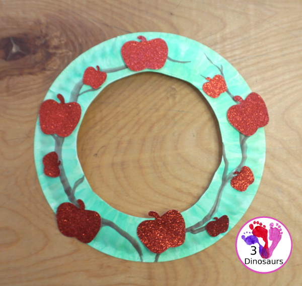 Apple Tree Wreath Craft for kids with paper plate, watercolor and apple punches to use to make this fun wreath for fall with a fun apple theme - 3Dinosaurs.com