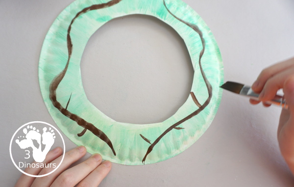 Apple Tree Wreath Craft for kids with paper plate, watercolor and apple punches to use to make this fun wreath for fall with a fun apple theme - 3Dinosaurs.com