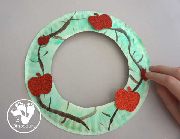 Apple Tree Wreath Craft for kids with paper plate, watercolor and apple punches to use to make this fun wreath for fall with a fun apple theme - 3Dinosaurs.com